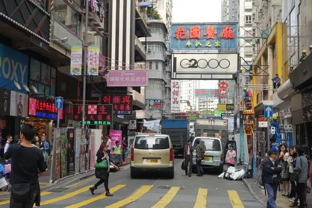 Busy city street lined with signs and storefronts