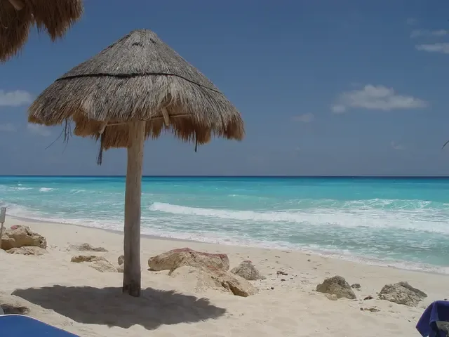 Turquoise shoreline with a thatched beach shade