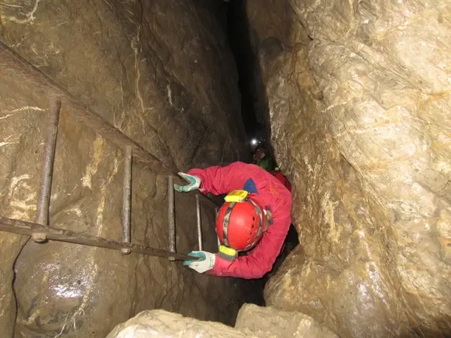 Caving adventure in a narrow rock passage